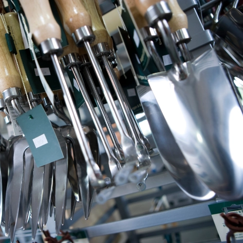 Metal garden hand tools hanging on a shop display