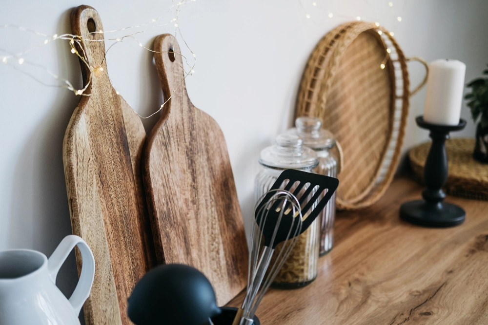 Wooden chopping boards and kitchen utensils on a homeware counter