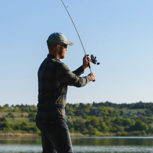 fishing with a rod beside a lake