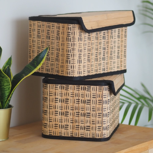 Patterned storage boxes stacked on a wooden shelf