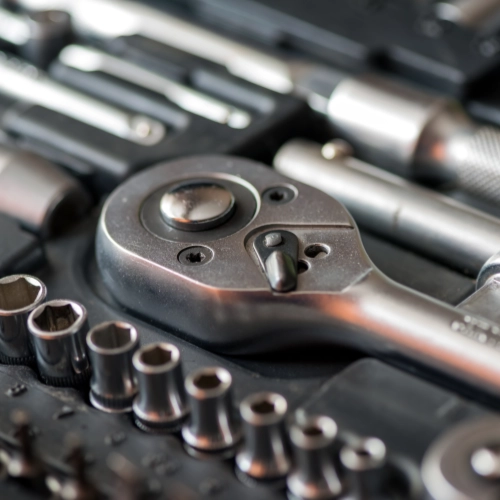 Close-up of a ratchet wrench and socket set in a tool case